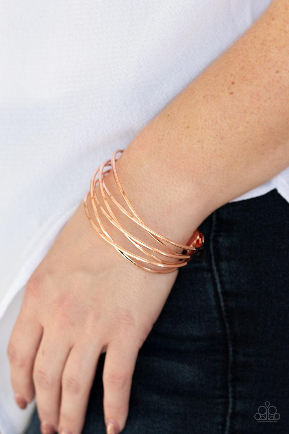Paparazzi Accessories Down To The Wire - Copper Shiny copper wires crisscross across the wrist, coalescing into an edgy cuff. Jewelry