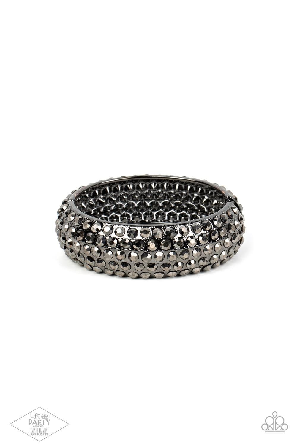 Paparazzi Accessories Making My Way Featuring a must-have hinged closure, the front of a thick gunmetal bangle is encrusted in row after row of smoky hematite rhinestones. The cuff-like bangle features a slight beveled surface, bringing the blinding spark