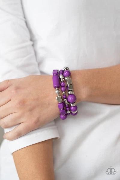 Paparazzi Accessories Perfectly Prismatic - Purple Featuring round, cube, and faceted shapes, a colorful collection of purple and silver beads are threaded along stretchy bands around the wrist, creating vivacious layers. Sold as one set of three bracelet