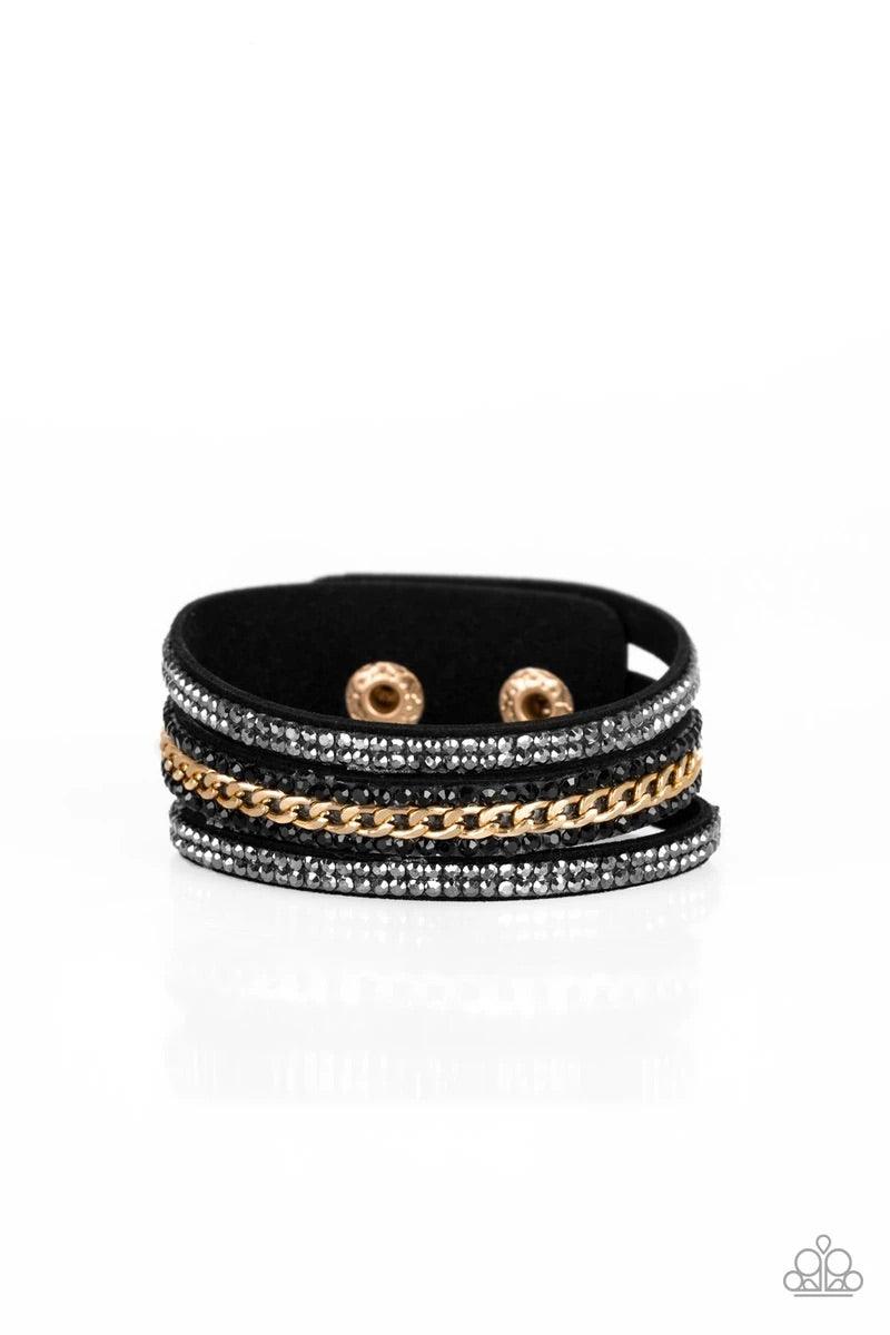 Paparazzi Accessories Rollin’ in Rhinestones - Black Rows of glassy hematite and black rhinestones and a shimmery gold chain are encrusted along black suede bands for a sassy look. Features an adjustable snap closure. Sold as one individual bracelet. Jewe
