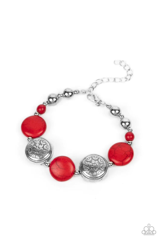 Paparazzi Accessories Oasis Orchard - Red Infused with silver beads and red stone accents, flat red stone beads alternate with floral silver frames along an invisible wire around the wrist for an earthy pop of color. Features an adjustable clasp closure.