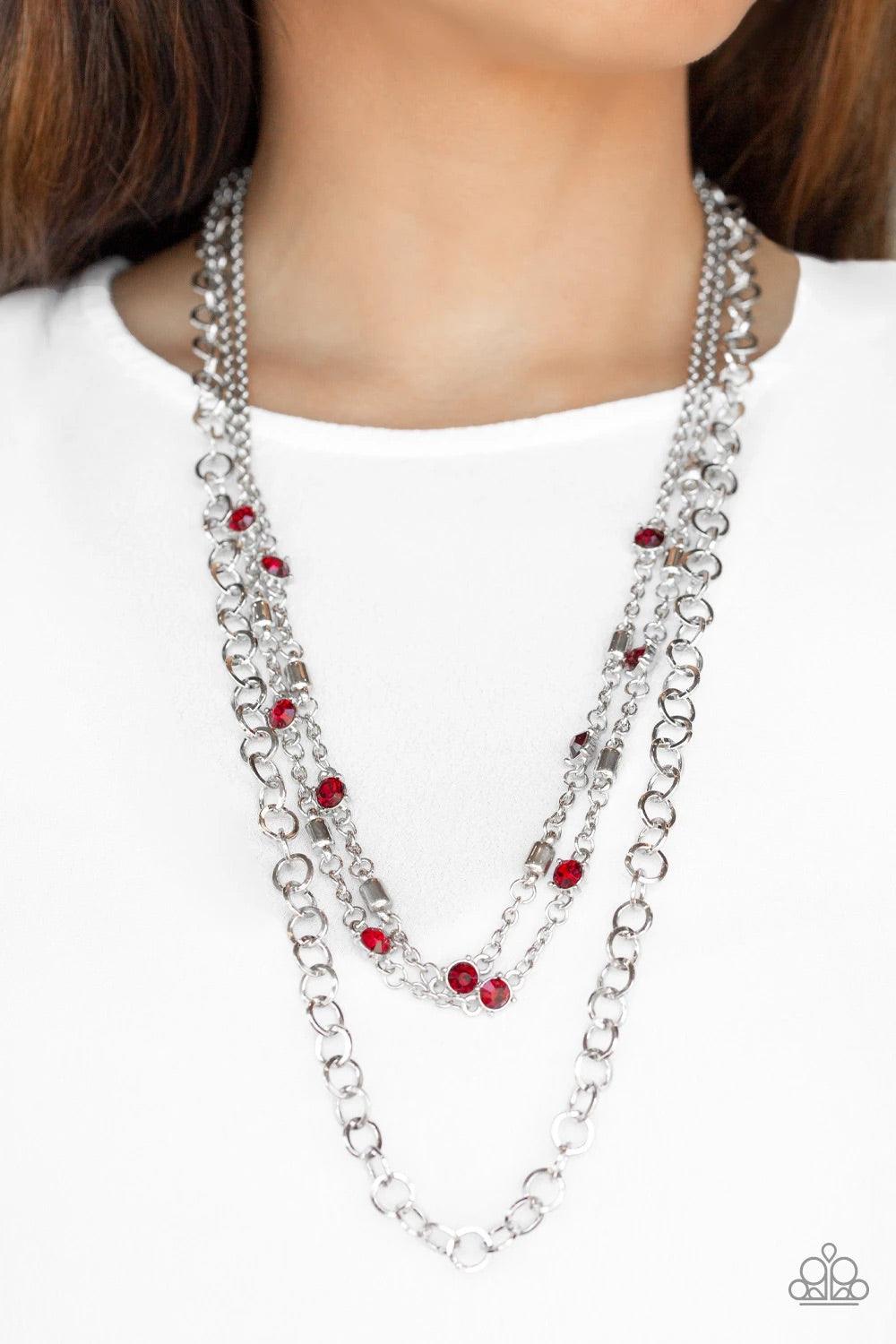 Paparazzi Accessories Metro Mixer - Red Dotted with glassy red rhinestones and glistening silver accents, a collision of mismatched silver chains layer down the chest for a refined flair. Features an adjustable clasp closure. Sold as one individual neckla