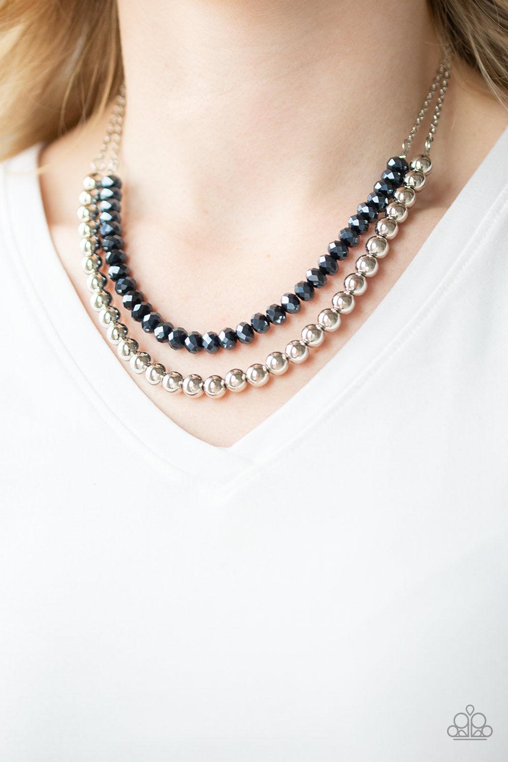 Paparazzi Accessories Color of the Day - Blue Dipped in a metallic shimmer, a strand of glittery blue crystal-like beads gives way to a strand of shiny silver beads below the collar for a colorfully layered look. Features an adjustable clasp closure. Jewe