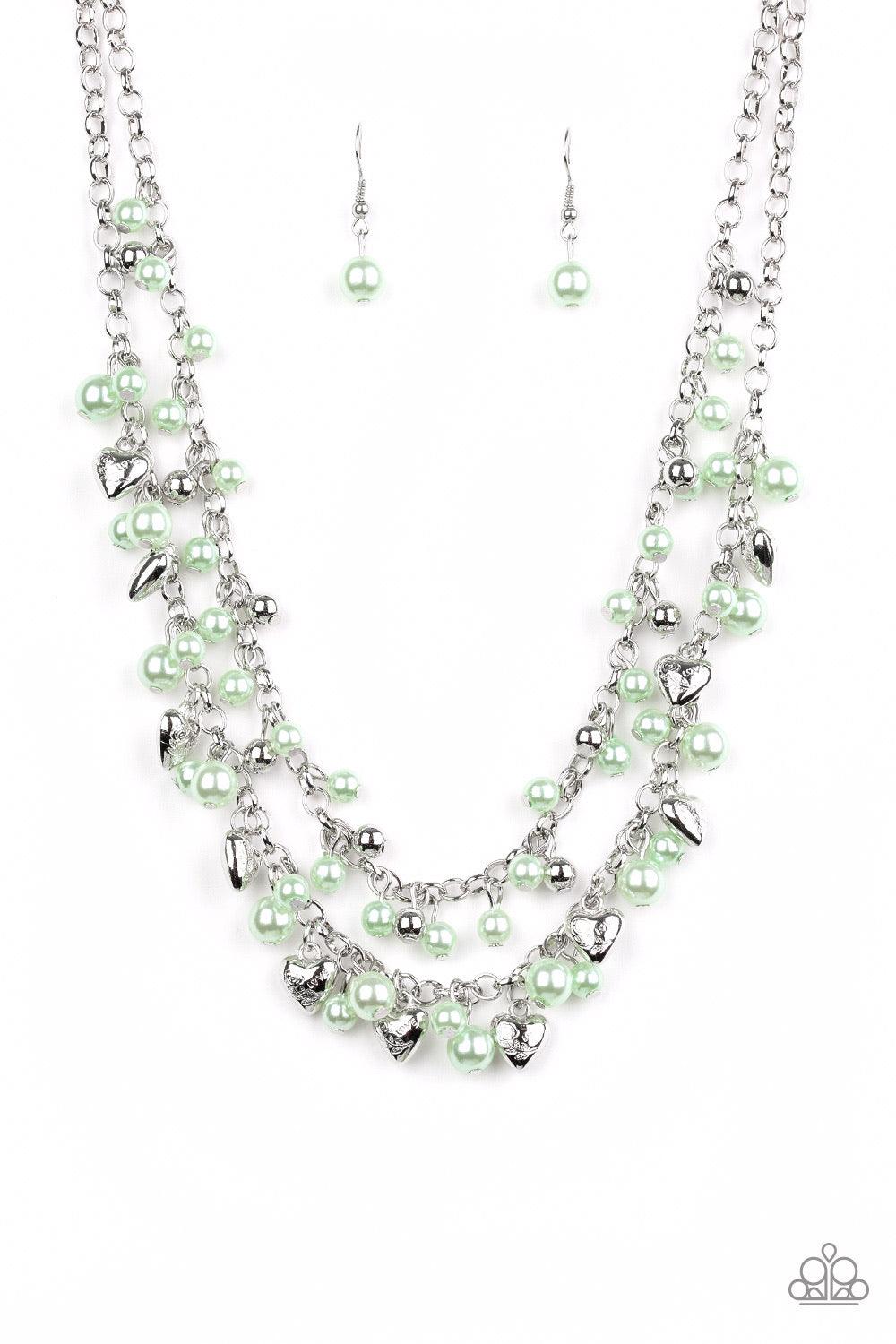 Paparazzi Accessories Kindhearted Heart - Green A collection of shiny silver beads and pearly green beads cascade from the bottoms of two layered silver chains. Stamped in the word, "Love", floral heart charms dangle from the lowermost chain, creating a f