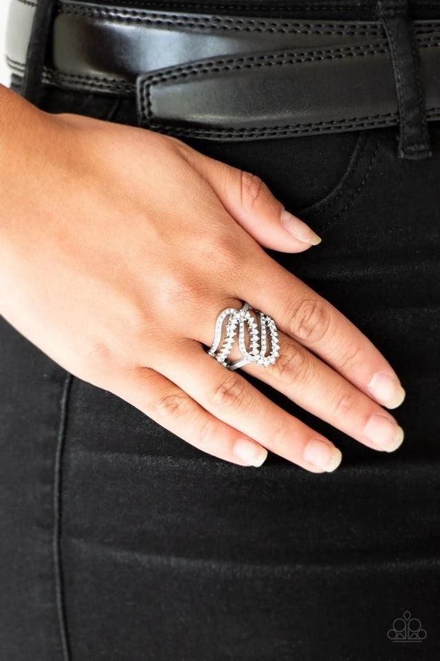 Paparazzi Accessories Make Waves - White Encrusted in dainty white rhinestones, radiant silver ribbons wave across the finger, coalescing into a whimsical band. Features a stretchy band for a flexible fit. Jewelry