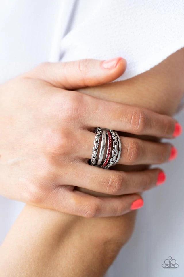 Paparazzi Accessories LINK Out Loud - Red Infused with a dainty band of glassy red rhinestones, layers of mismatched silver bands and chains stack across the finger in a bold finish. Features a stretchy band for a flexible fit. Jewelry