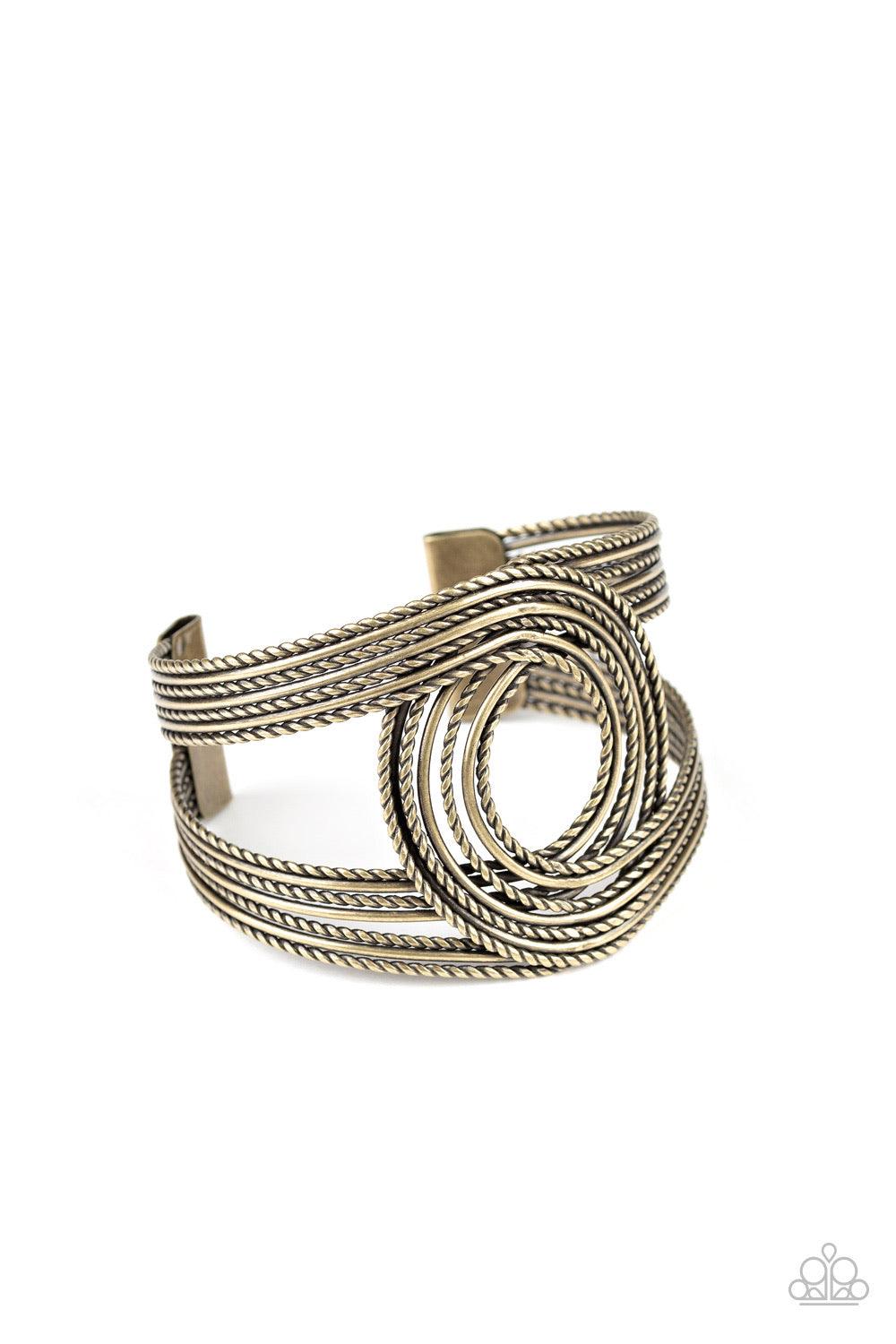 Paparazzi Accessories Rustic Coils - Brass Brushed in an antiqued finish smooth and twisted rope-like brass wires loop and curl around the wrist, creating a rustic cuff. Jewelry