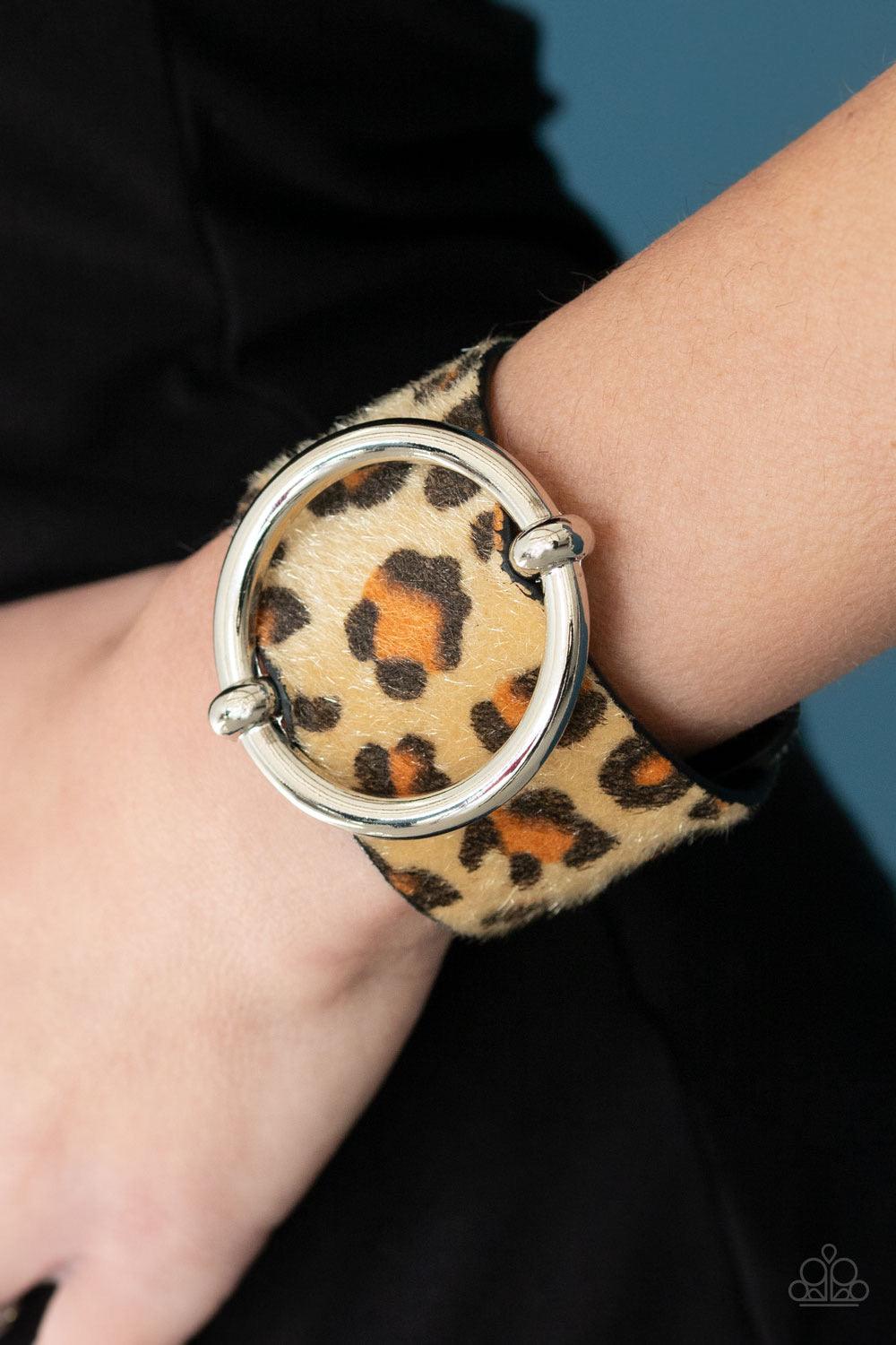 Paparazzi Accessories Asking FUR Trouble - Brown A dramatically oversized silver ring slides along a thick black leather band featuring fuzzy brown cheetah print for a wild finish. Features an adjustable snap closure. Sold as one individual bracelet. Jewe