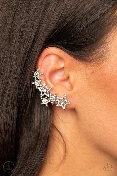 Paparazzi Accessories Star-Spangled Shimmer - White A stellar display of white rhinestone encrusted stars curve up the ear, coalescing into a sparkle-spangled statement piece. Earring attaches to a standard post fitting. Features a clip-on fitting on the