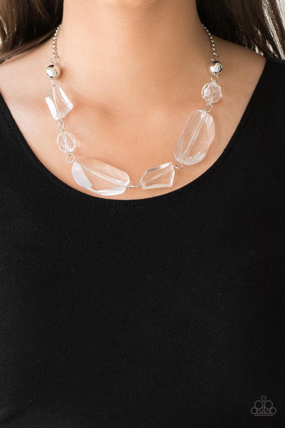 Paparazzi Accessories Luminous Luminary - White A dainty white rhinestone encrusted heart frame swings from the top of an oversized silver heart frame, creating a charming duo. Earring attaches to a standard fishhook fitting. Jewelry