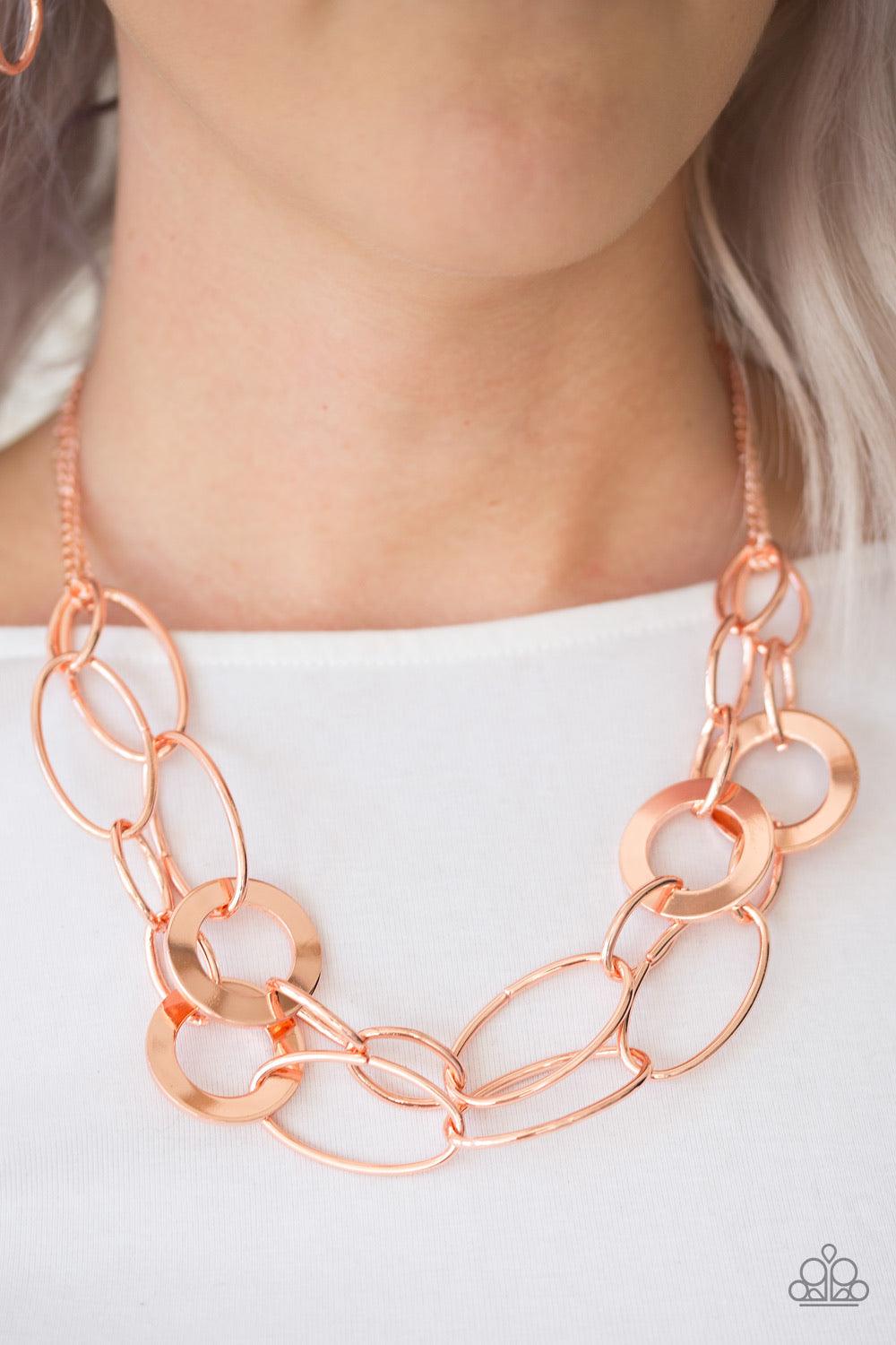 Paparazzi Accessories Metallic Maverick - Copper Mismatched shiny copper rings and hoops link below the collar in bold layers for a spunky industrial look. Features an adjustable clasp closure. Sold as one individual necklace. Includes one pair of matchin