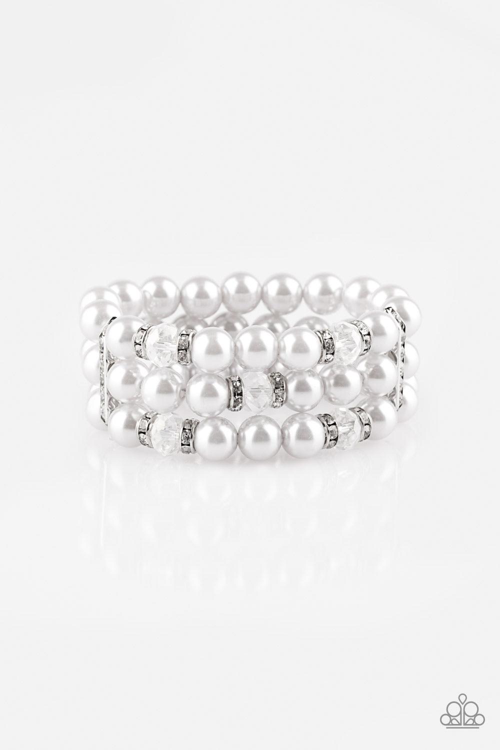 Paparazzi Accessories Undeniable Dapper ~Silver Pinched between white rhinestone encrusted frames, white rhinestone encrusted rings, crystal-beads, and silver pearls are threaded along elastic stretchy bands for a glamorous look.