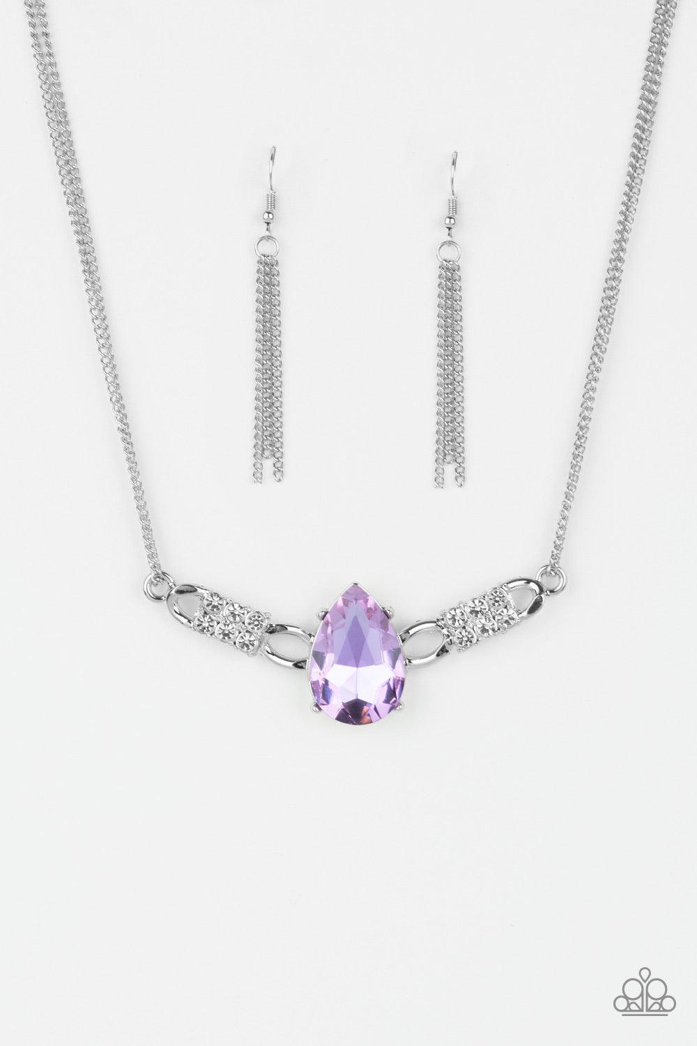 Paparazzi Accessories Way To Make An Entrance - Purple Cut into an alluring teardrop, an oversized purple rhinestone gem attaches to bold silver frames radiating with glassy white rhinestones. The dramatic pendant attaches to doubled silver chains, swingi