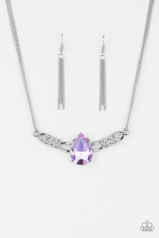 Paparazzi Accessories Way To Make An Entrance - Purple Cut into an alluring teardrop, an oversized purple rhinestone gem attaches to bold silver frames radiating with glassy white rhinestones. The dramatic pendant attaches to doubled silver chains, swingi