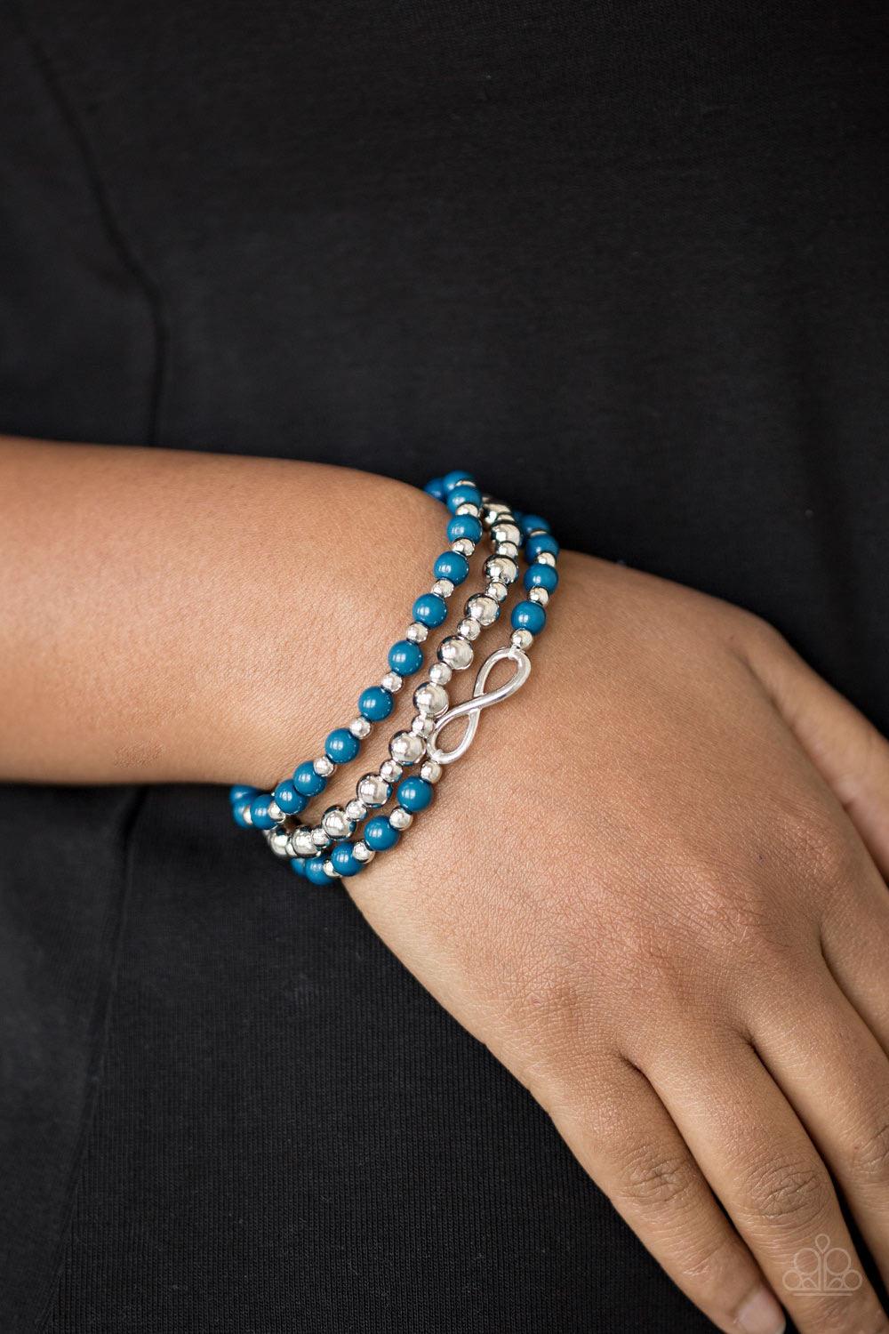 Paparazzi Accessories Immeasurably Infinite -Blue Refreshing blue and shiny silver beads are threaded along stretchy bands, creating colorful layers around the wrist. A dainty silver infinity charm adorns one strand for a whimsical finish. Sold as one set