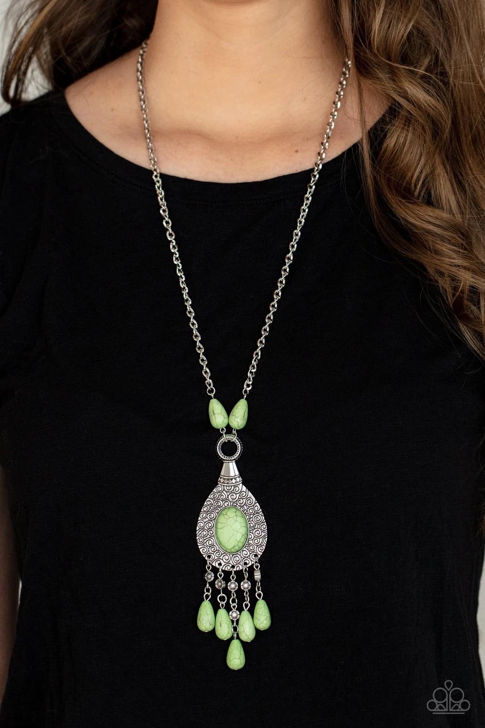 Paparazzi Accessories Cowgirl Couture - Green An Apple Green oval stone sits center stage surrounded by swirly designs stamped into a wide silver frame. A fringe of silver floral beads culminating in Apple Green stones swings like a pendulum at the end of