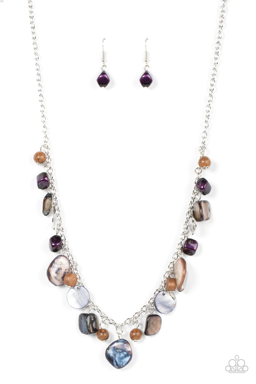 Paparazzi Accessories Caribbean Charisma - Purple A mismatched collection of warped silver discs, brown wooden beads, and iridescent shell-like rock accents dances from the bottom of a classic silver chain, creating a tropical sensation across the chest.