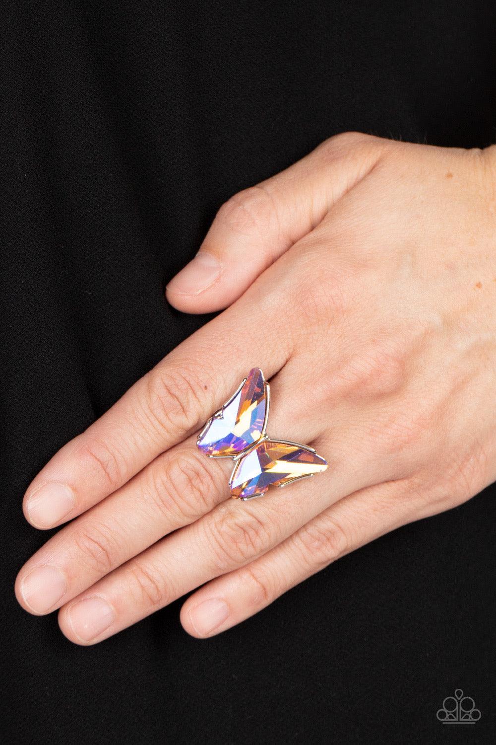 Paparazzi Accessories Fluorescent Flutter - Orange Featuring a stellar UV finish, a pair of glittery orange gems adorns the wings of a silver butterfly atop the finger for an eye-catching finish. Features a stretchy band for a flexible fit. Due to its pri