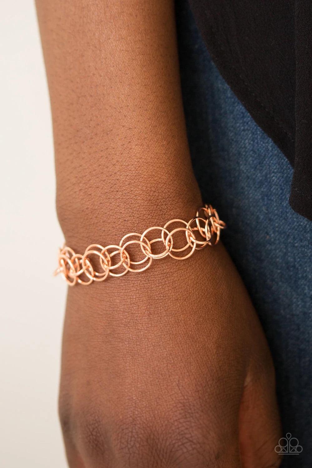 Paparazzi Accessories Contemporary Circus - Copper Varying in size, rows of shiny copper rings interlock across the wrist for a bold industrial look. Features an adjustable clasp closure. Sold as one individual bracelet. Jewelry