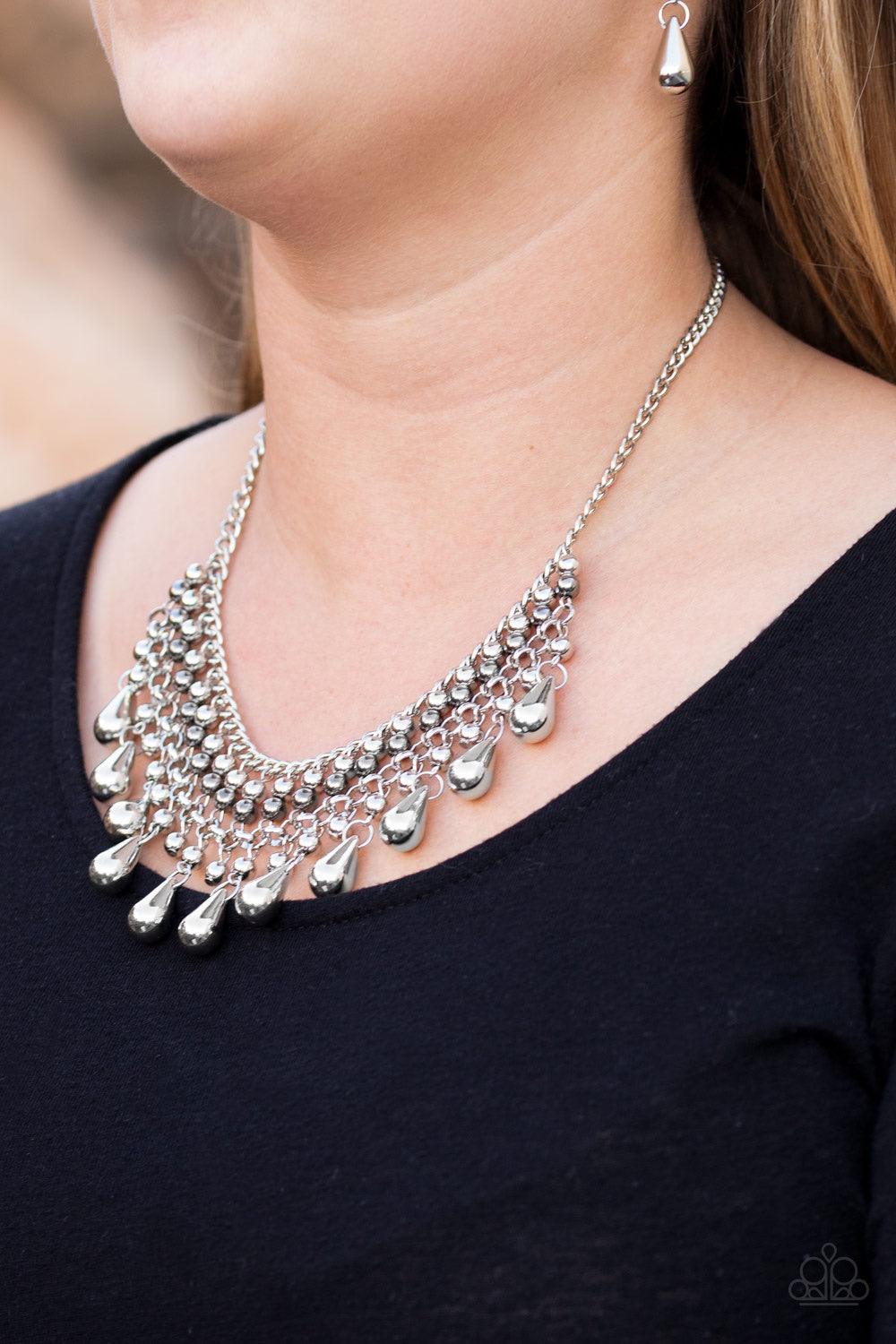 Paparazzi Accessories Don’t Forget To BOSS! - Silver Threaded along metallic rods, stacked silver and gunmetal beads give way to shimmery silver teardrops. The edgy fringe flawlessly drapes beneath the collar, creating a sassy tapered fringe. Features an