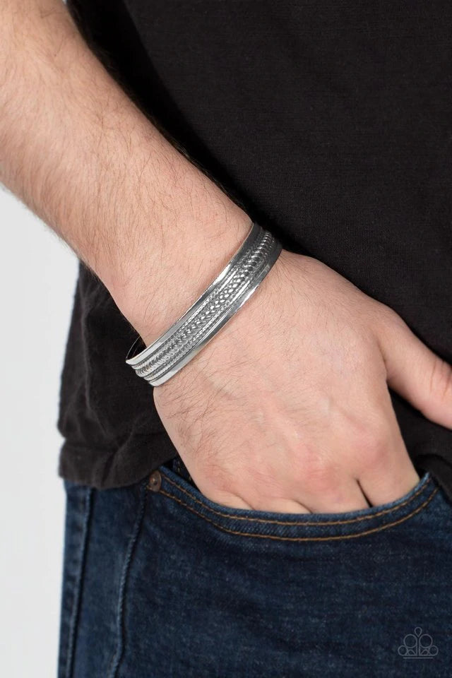 Paparazzi Accessories Urban Expedition - Silver The center of a rustic silver cuff is embossed in metallic rope-like texture, creating a tribal inspired centerpiece around the wrist. Jewelry