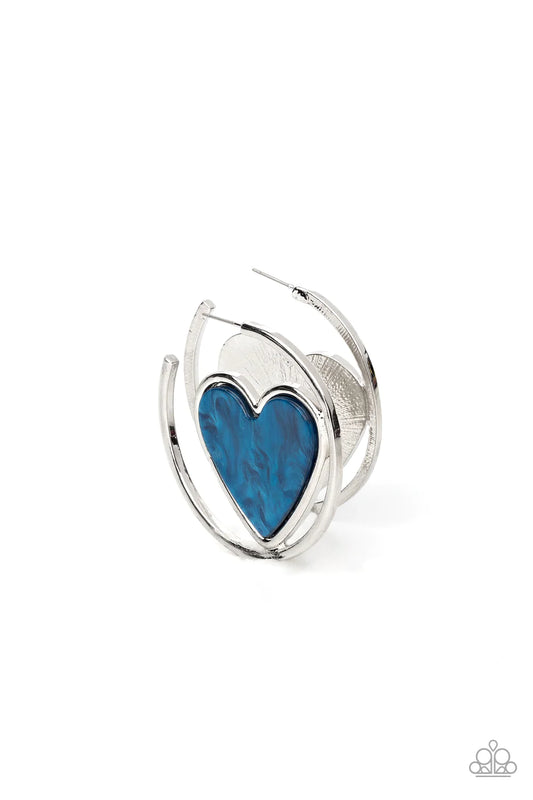 Paparazzi Accessories Smitten With You - Blue Featuring a faux marble finish, a glistening blue heart nestles inside of an asymmetrical silver hoop for a flirtatious pop of color. Earring attaches to a standard post fitting. Hoop measures approximately 2"