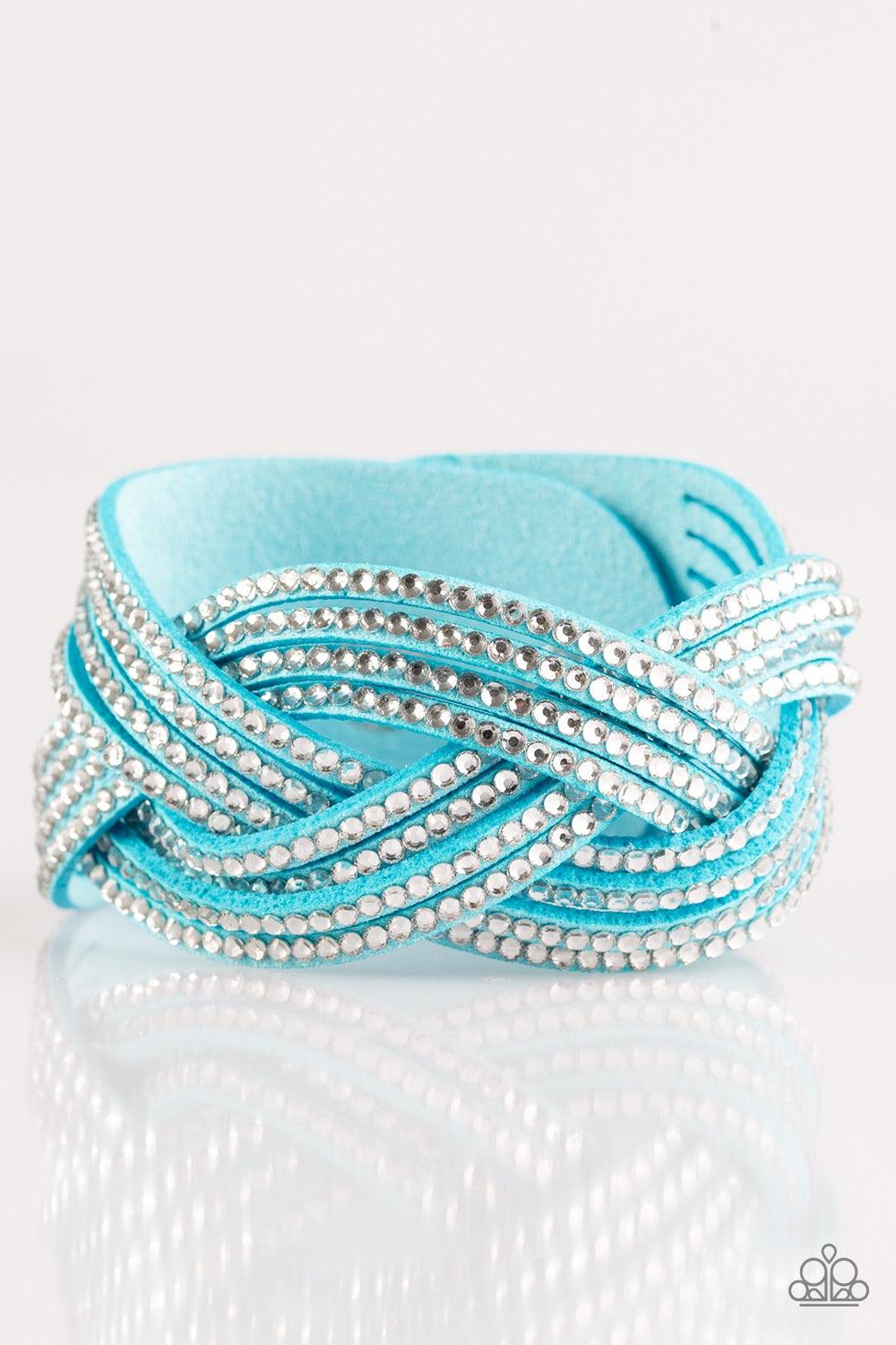 Paparazzi Accessories Big City Shimmer - Blue Glassy white rhinestones are encrusted along crisscrossing strands of blue suede, creating bold shimmer around the wrist. Features an adjustable snap closure. Jewelry