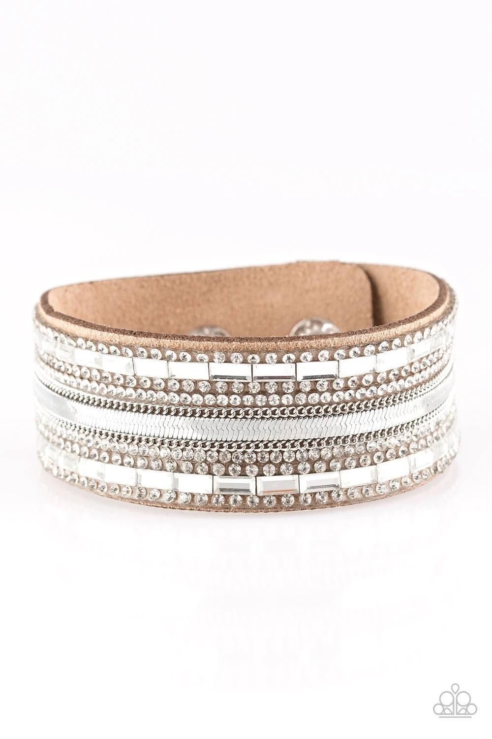 Paparazzi Accessories Teasingly Tomboy - Brown Mismatched silver chains, glassy emerald-cut, and glittery white rhinestones are encrusted along a thick brown suede band for a sassy look. Features an adjustable snap closure. Sold as one individual bracelet