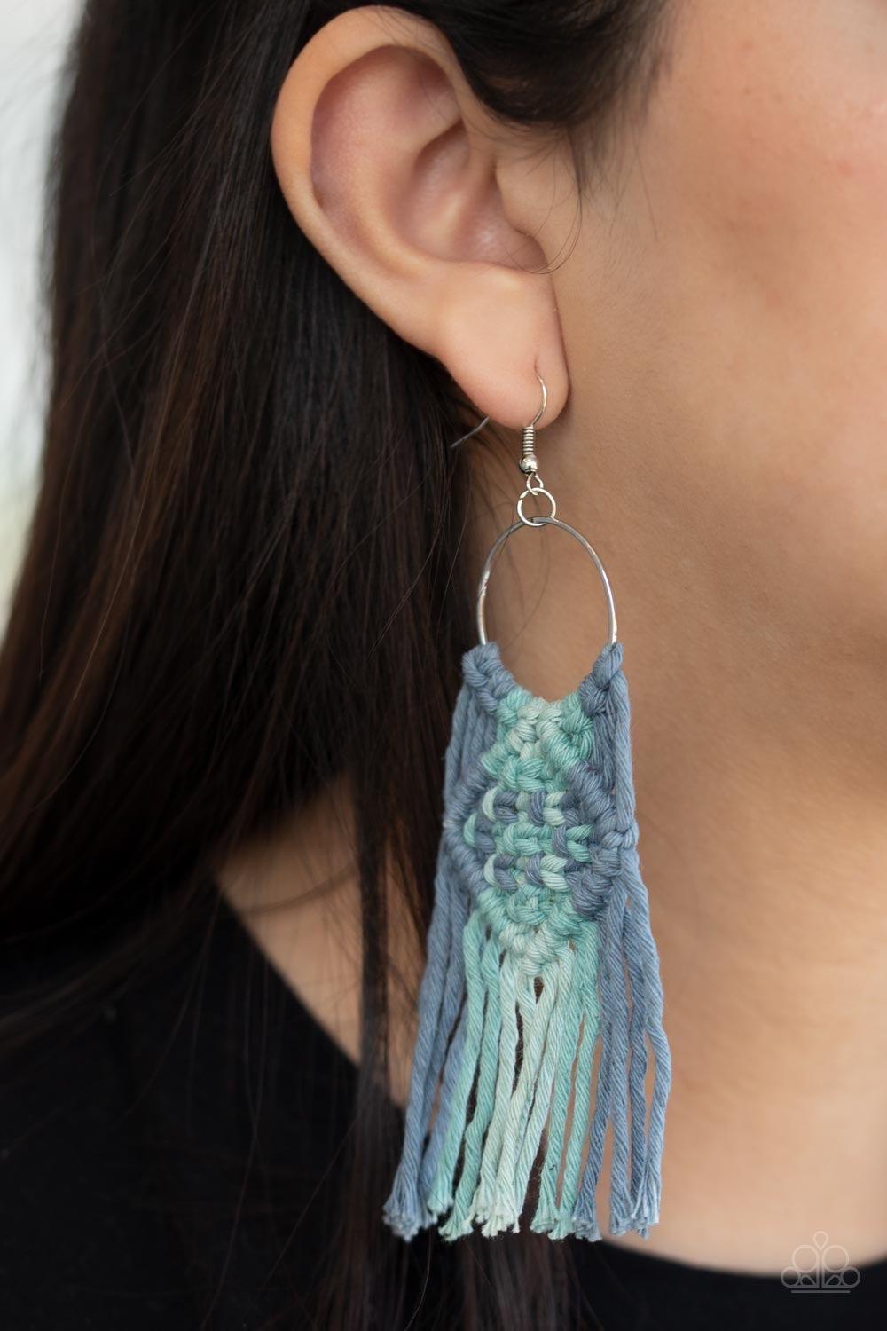 Paparazzi Accessories Macrame Rainbow - Blue An ombre of mixed blue cording knots around the bottom of a dainty silver hoop, weaving into a colorful macramé fringe. Earring attaches to a standard fishhook fitting. Jewelry