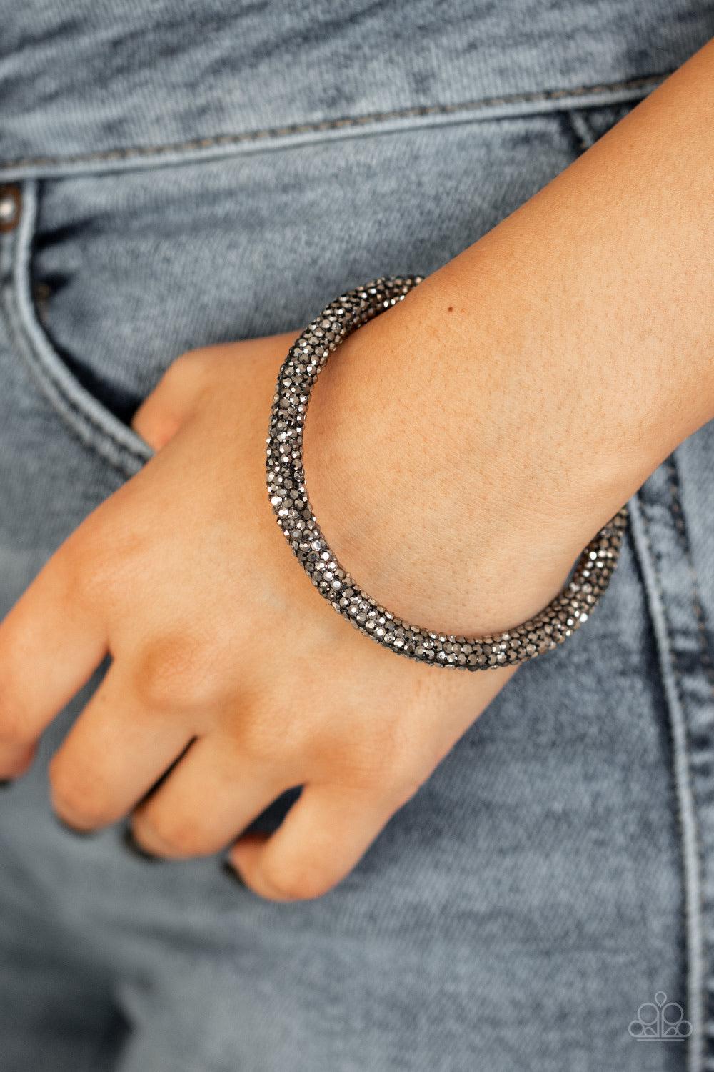 Paparazzi Accessories Stageworthy Sparkle - Black Bedazzled in glittery hematite rhinestones, a bendable cuff-like bracelet delicately curls around the wrist for a refined look. Jewelry