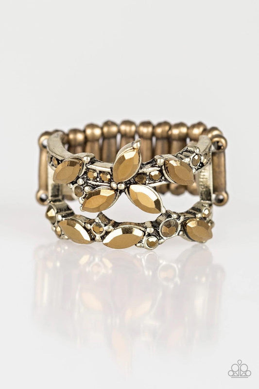 Paparazzi Accessories Cosmo Collection - Brass Featuring round and regal marquise style cuts, glittery aurum rhinestones stack across the finger in two glittery bands. Features a stretchy band for a flexible fit. Sold as one individual ring. Jewelry