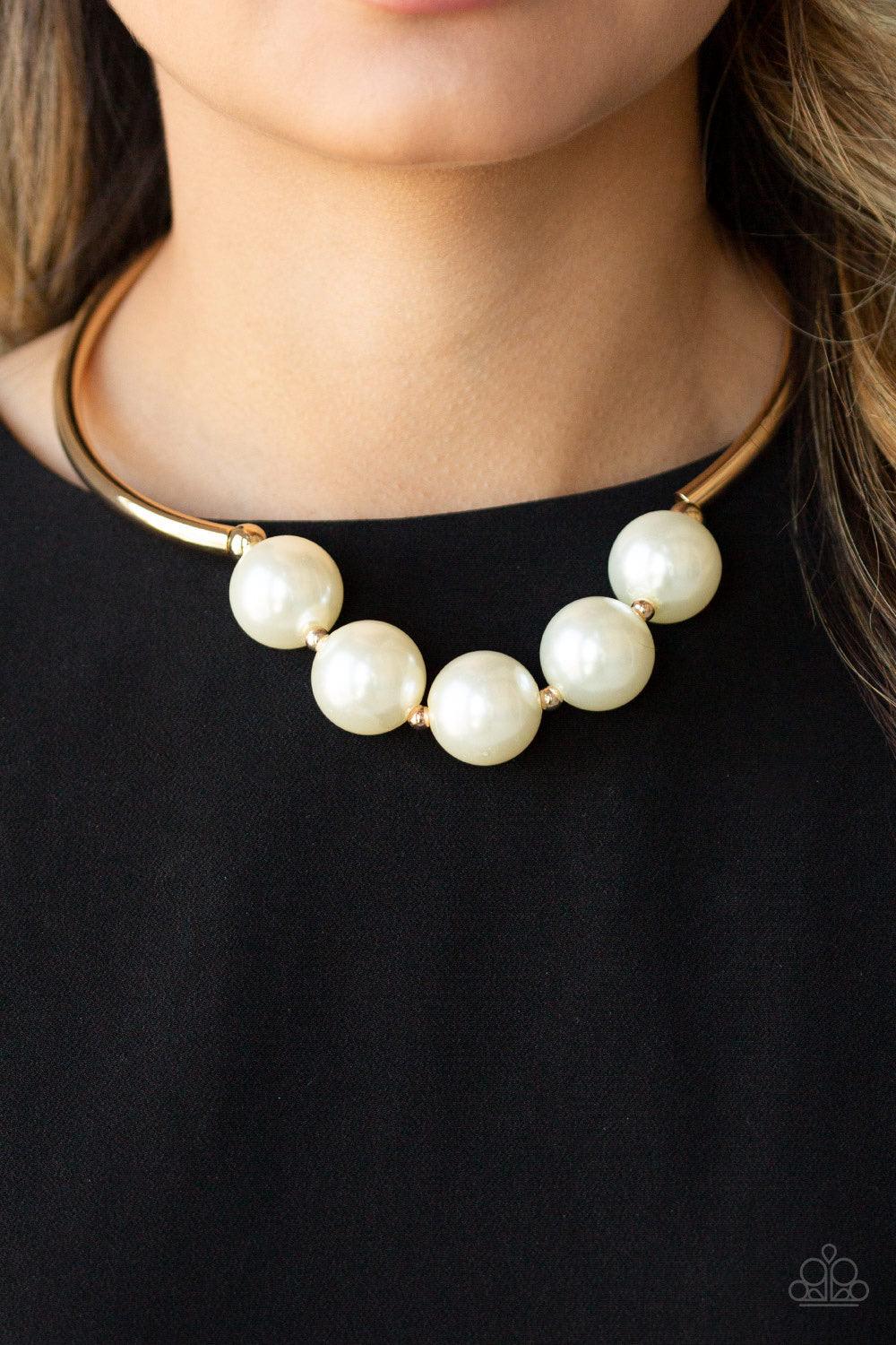 Paparazzi Accessories Welcome To Wall Street - Gold Threaded along an invisible wire, two arching gold bars give way to a collection of dainty gold beads and oversized white pearls for a dramatic look below the collar. Features an adjustable clasp closure