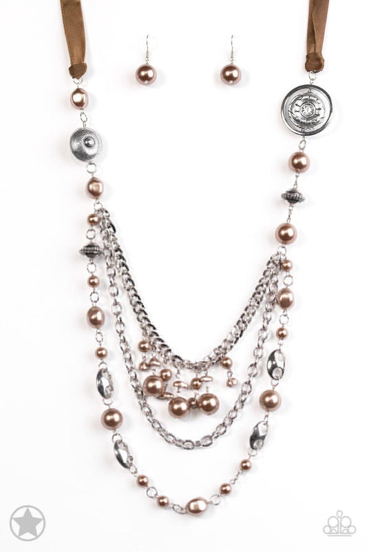 Paparazzi Accessories All The Trimmings - Brown A silky brown ribbon replaces a traditional chain to give an elegant look. Pearly brown beads and funky silver pieces intermix with varying lengths of silver chains to give a fresh take on a Victorian-inspir