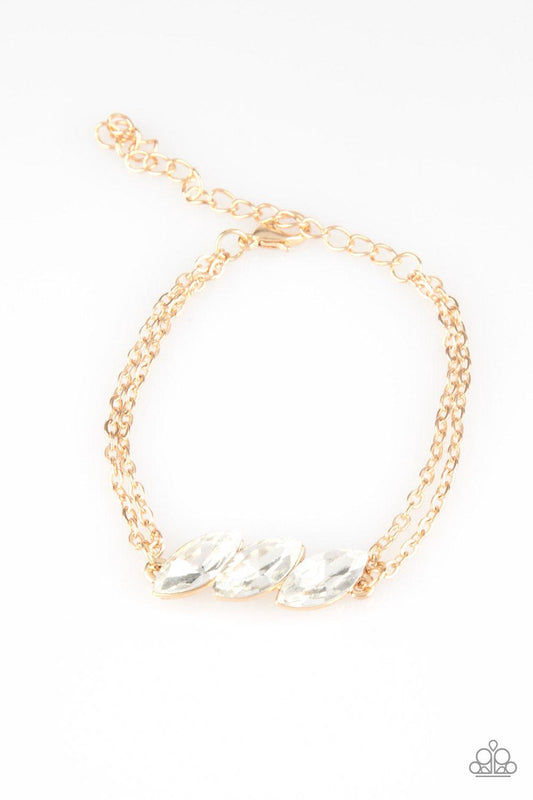 Paparazzi Accessories Pretty Priceless - Gold Featuring regal marquise-cuts, a trio of glittery white rhinestones join across the center of the wrist for a timeless look. Features an adjustable clasp closure. Sold as one individual bracelet. Jewelry