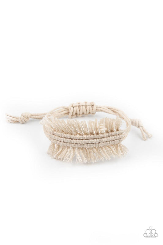Paparazzi Accessories Make Yourself at HOMESPUN - White Strands of shiny white twine-like cording decoratively knot around the wrist, creating a rustic fringed centerpiece. Features an adjustable sliding knot closure. Sold as one individual bracelet. Jewe