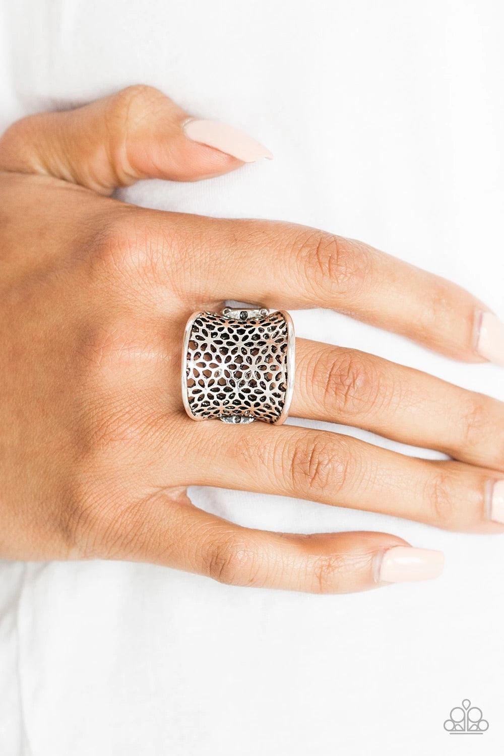 Paparazzi Accessories Garden Safari- Silver Stenciled in an airy floral pattern, a thick silver band curls around the finger for a whimsical springtime look. Features a stretchy band for a flexible fit. Sold as one individual ring. Jewelry
