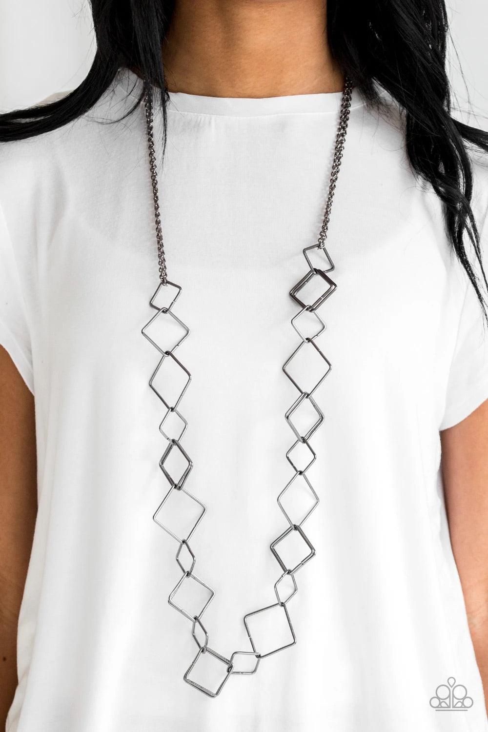 Paparazzi Accessories Backed Into A Corner - Black Varying in size, airy gunmetal square silhouettes link across the chest for an edgy look. Features an adjustable clasp closure. Sold as one individual necklace. Includes one pair of matching earrings. Jew