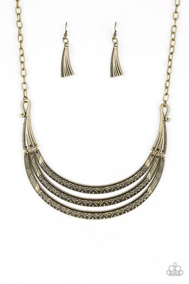 Paparazzi Accessories Primal Princess - Brass Embossed in zigzagging patterns, brass crescents swing from two ornate brass plates for a tribal inspired look. Dotted with studded textures, the antiqued pendants delicately stack below the collar for a bold