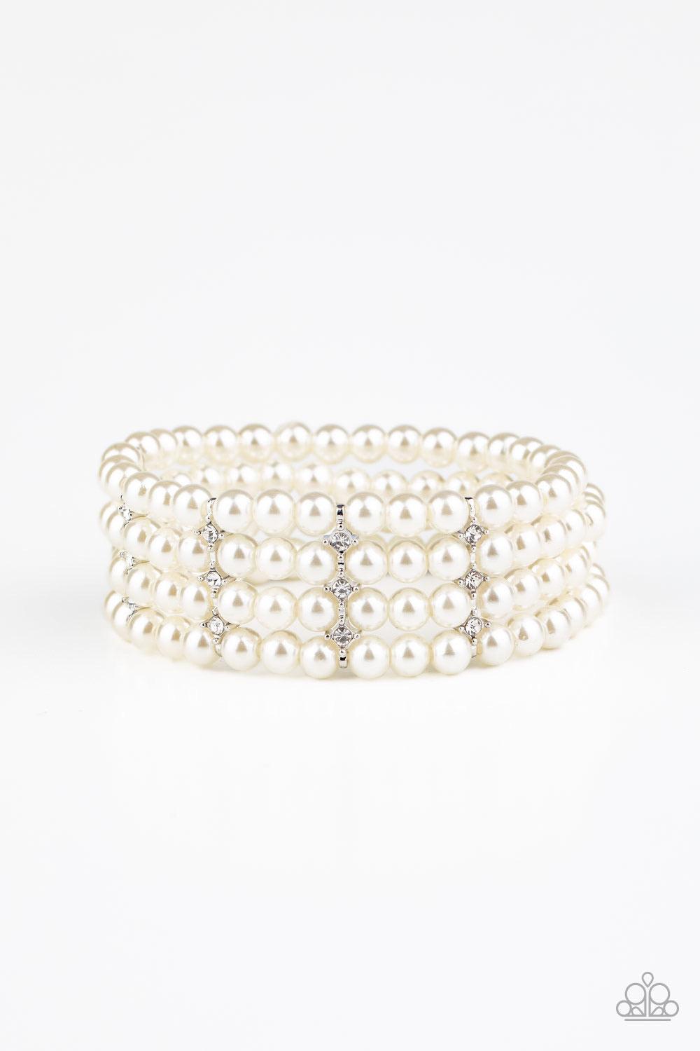 Paparazzi Accessories Stacked To The Top - White Held together by glittery white rhinestone encrusted silver fittings, row after row of white pearls are threaded along stretchy bands around the wrist for a timelessly stacked look. Sold as one individual b