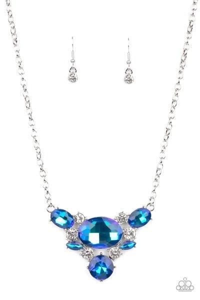 Paparazzi Accessories Cosmic Coronation - Blue Featuring a UV shimmer, oversized blue iridescent gems and glassy white rhinestones delicately coalesce into a v-shaped pendant below the collar for over-the-top glamour. Features an adjustable clasp closure.