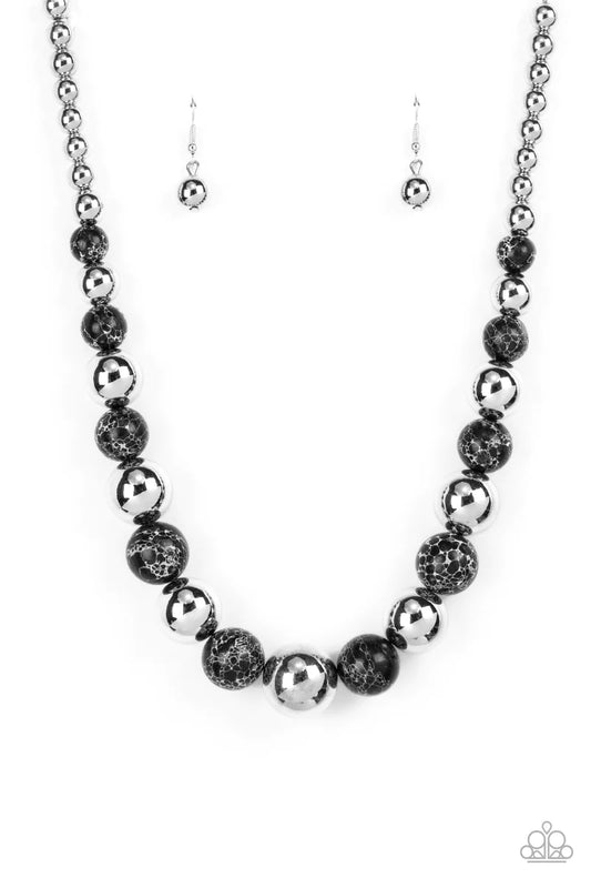 Paparazzi Accessories Stone Age Adventurer - Black Featuring a black and white marble finish, an earthy collection of faux stone and classic silver beads gradually increase in size as they alternate below the collar for a statement-making look. Features a