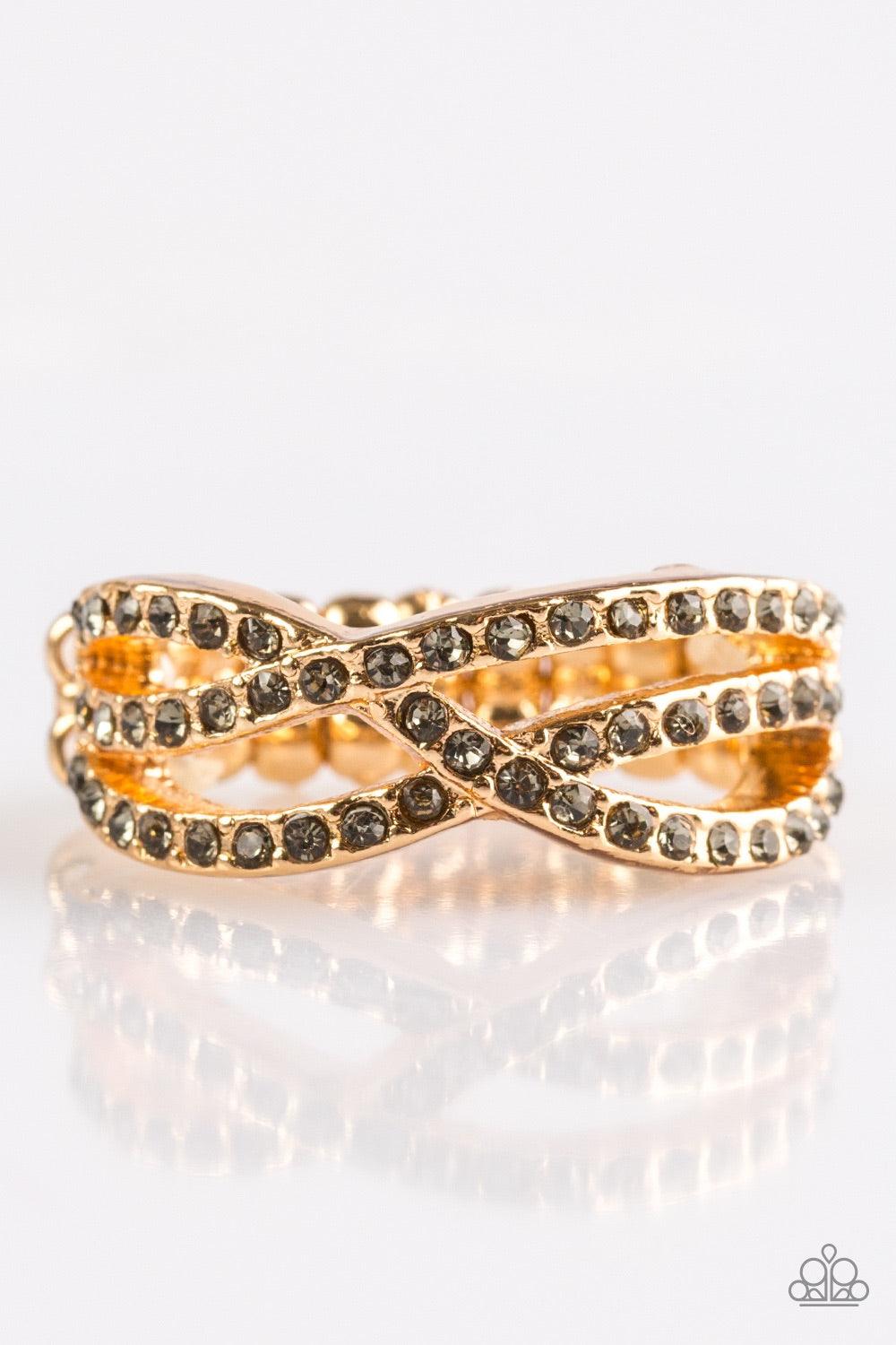 Paparazzi Accessories CACHE Advance - Gold Encrusted in glittery smoky rhinestones, shimmery ribbons of gold crisscross across the finger in a timeless fashion. Features a dainty stretchy band for a flexible fit. Jewelry