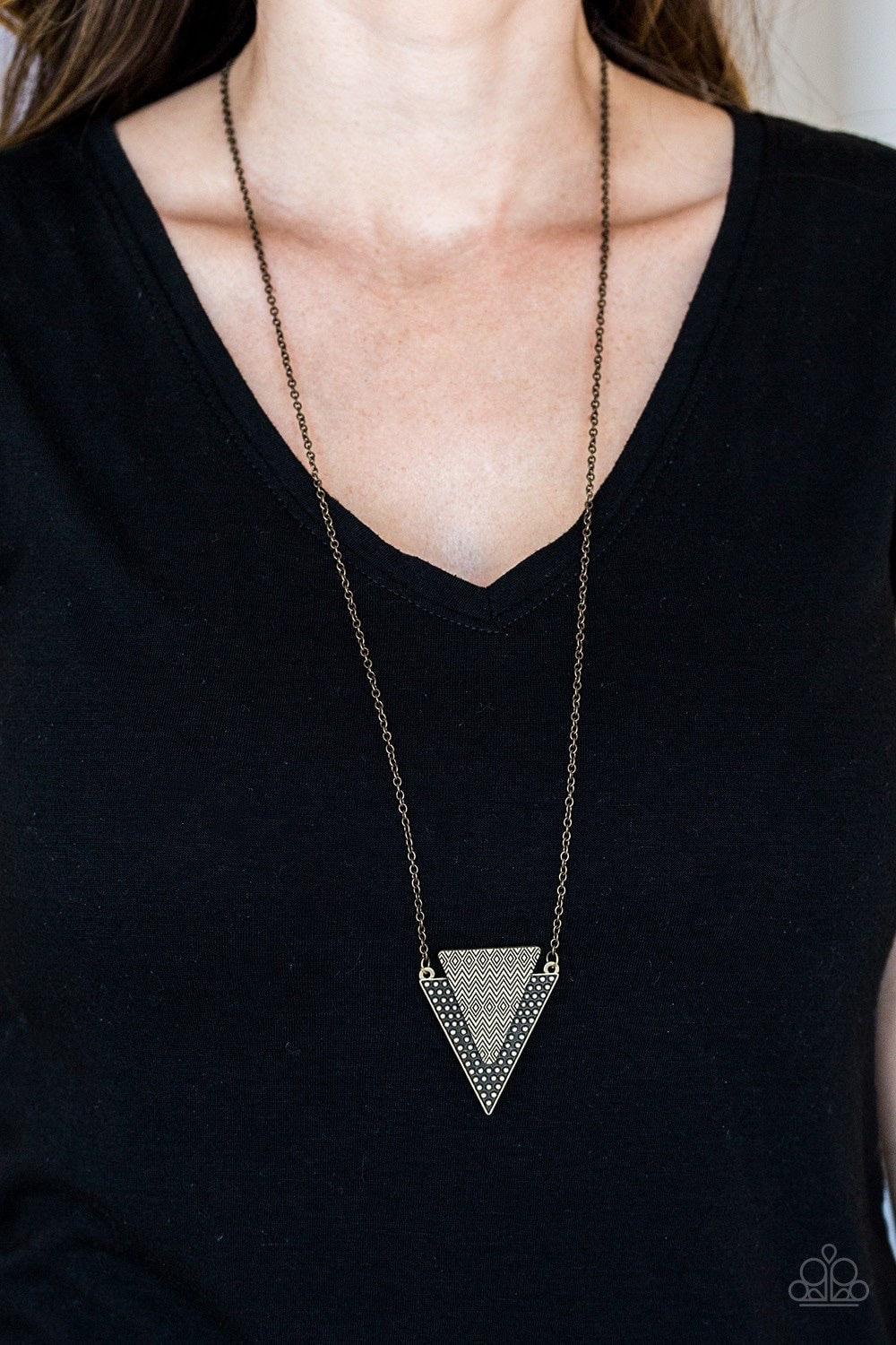 Paparazzi Accessories Ancient Arrow - Brass Stamped and studded in indigenous inspired textures, a stacked triangular pendant swings from the bottom of an elongated brass chain for a trendy tribal look. Features an adjustable clasp closure. Jewelry