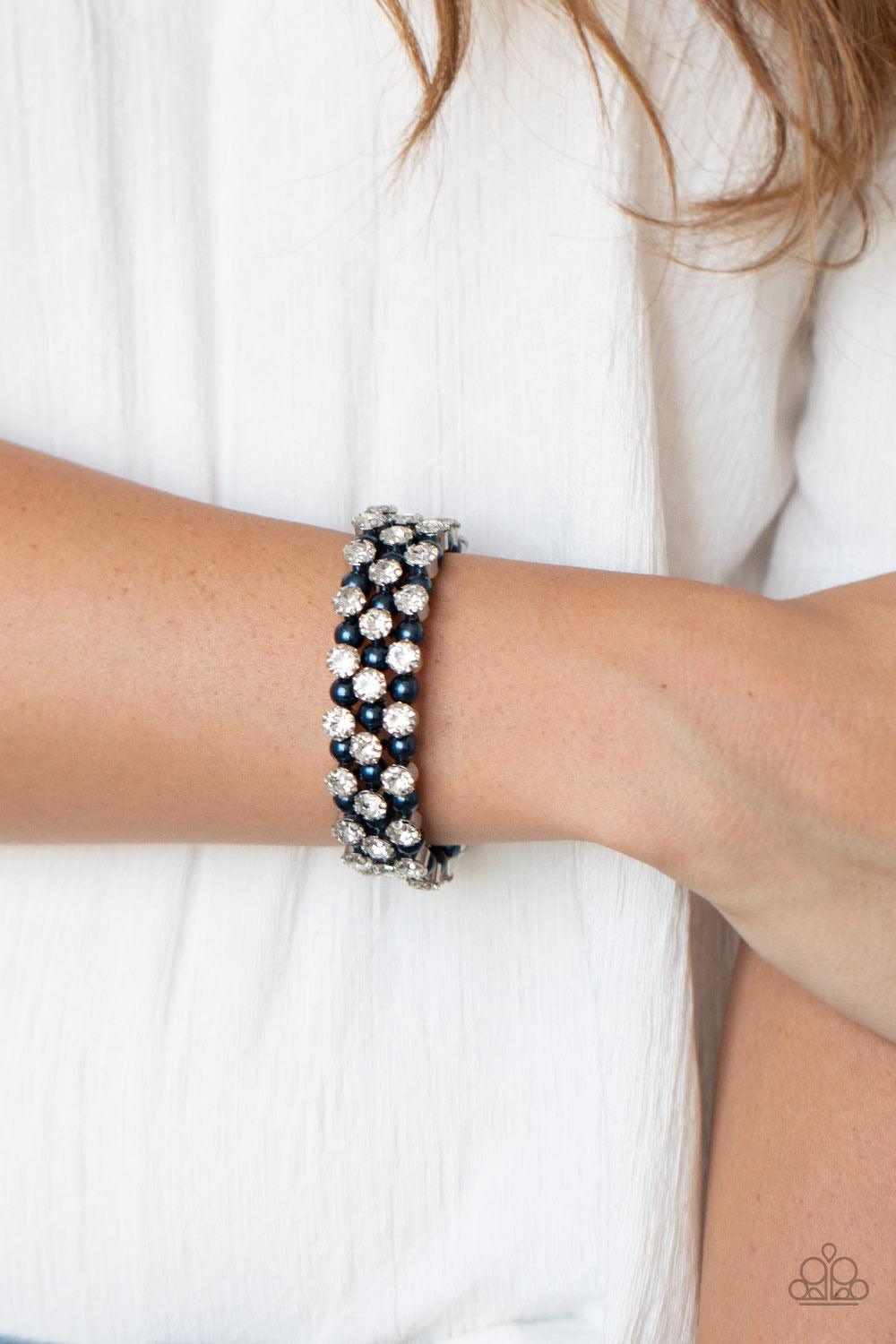 Paparazzi Accessories Metro Motif - Blue Glittery white rhinestones alternate with classy blue pearls along a coiled wire, creating an elegant infinity wrap bracelet around the wrist. Sold as one individual bracelet. Jewelry