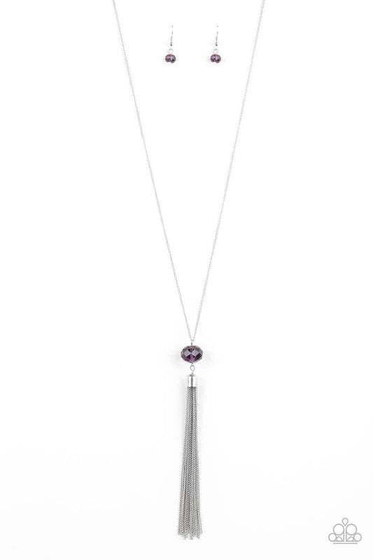 Paparazzi Accessories Socialite of the Season - Purple A glittery purple crystal-like bead swings from the bottom of a lengthened silver chain, giving way to a shimmering silver tassel for a glamorous finish. Features an adjustable clasp closure. Sold as