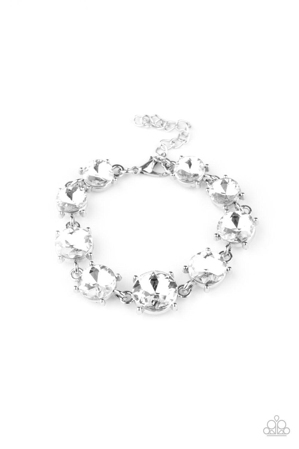 Paparazzi Accessories Can’t Believe My ICE - White Gradually increasing in size at the center, a dramatic row of exaggerated white rhinestone encrusted silver frames delicately link around the wrist for a statement-making sparkle. Features an adjustable c