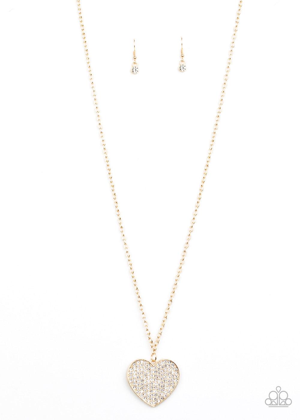 Paparazzi Accessories Have To Learn The HEART Way - Gold Encrusted in row after row of glassy white rhinestones, a dazzling gold heart swings from the bottom of a lengthened gold chain for a charming finish. Features an adjustable clasp closure. Sold as o