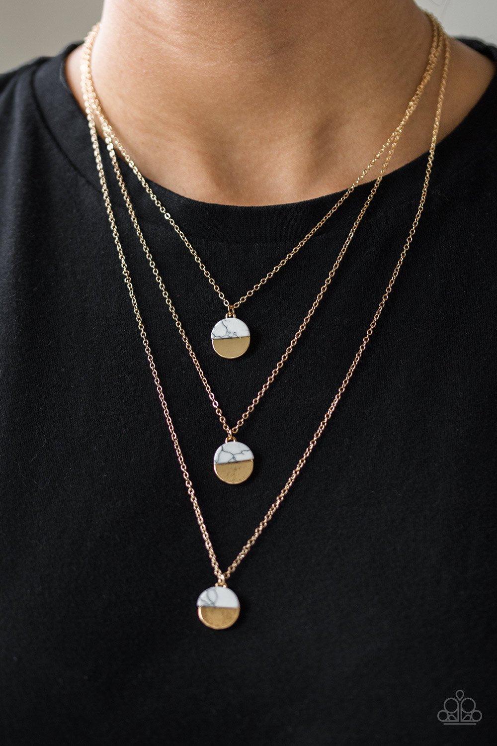 Paparazzi Accessories Rural Reconstruction - Gold Featuring refreshing white stone accents, a trio of gold discs layer down the chest for a seasonal look. Features an adjustable clasp closure. Sold as one individual necklace. Includes one pair of matching