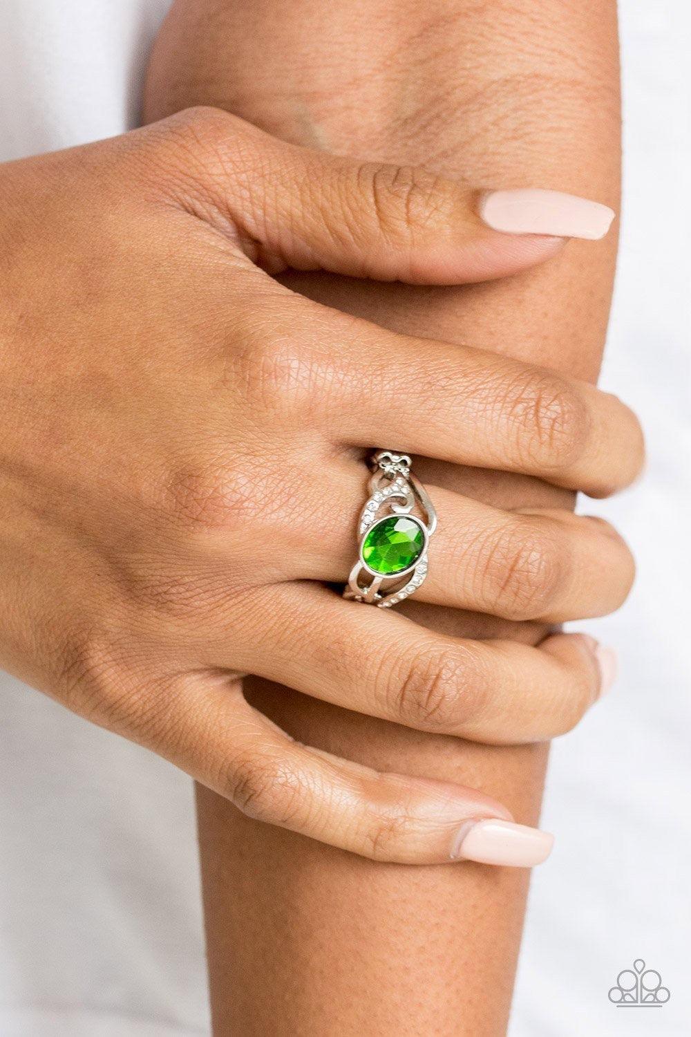 Paparazzi Accessories Couldn’t Care FLAWLESS - Green Encrusted in sections of glassy white rhinestones, shimmery silver filigree curls around a glittery green rhinestone center for a refined flair. Features a dainty stretchy band for a flexible fit. Jewel