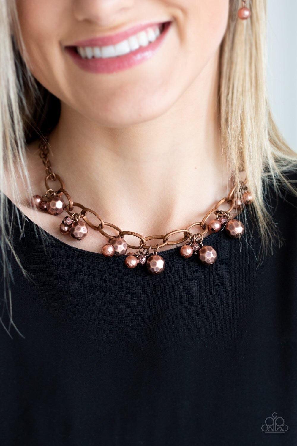 Paparazzi Accessories Malibu Movement - Copper Varying in size, a collection of faceted copper and pearly copper beads swing from a bold copper chain, creating a whimsical metallic fringe below the collar. Features an adjustable clasp closure. Sold as one